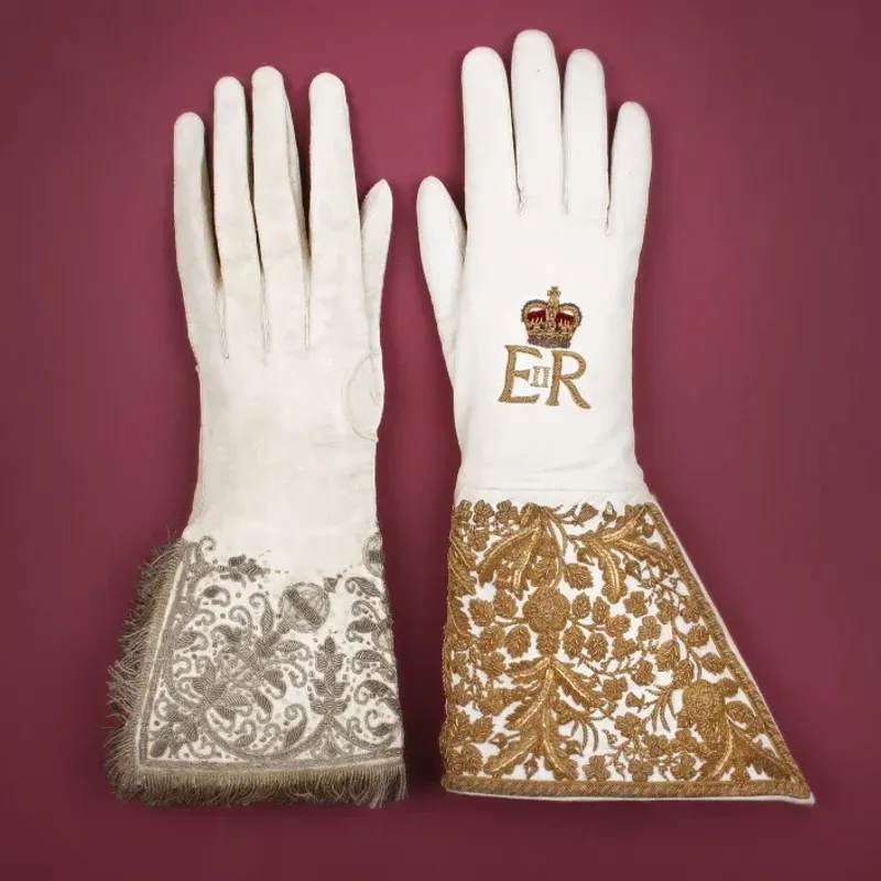 Elizabeth I’s coronation glove (left) and Elizabeth II’s coronation glove (right). Credit: Dents.
