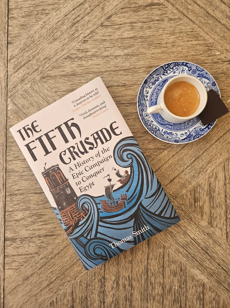 Julia holding a copy of The Fifth Crusade by Thomas Smith