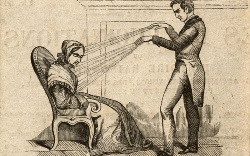 An illustration of a mesmerism session, where an individual attempts to use mesmerism to heal or influence another through magnetic fields.